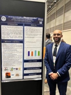 Dental student David Knowles in front of a research poster. 