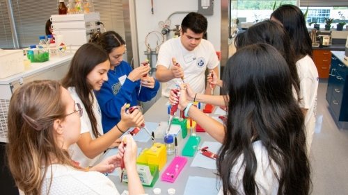 High school students practicing pipetting.